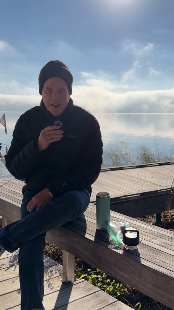 Bower on a dock by the Susquehanna with a cup of tea on a fog-covered morning