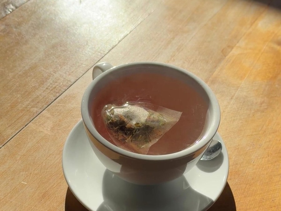 A cup of tea in afternoon sun on a wooden table